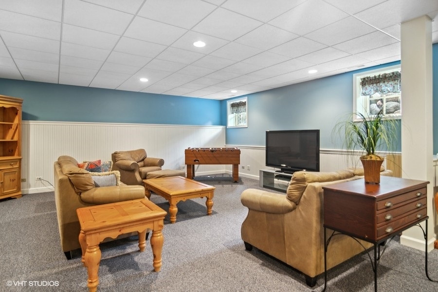 433 Signal Hill Road North Barrington, IL 60010 - Photo 25 of 44 a living room with furniture a flat screen tv and a table