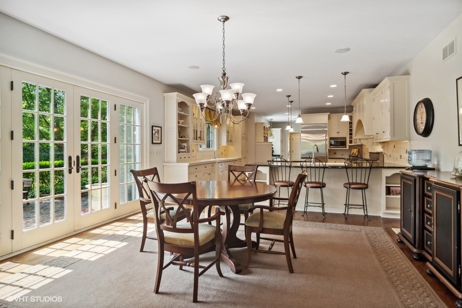 433 Signal Hill Road North Barrington, IL 60010 - Photo 8 of 44 a dining room filled chandelier and kitchen view