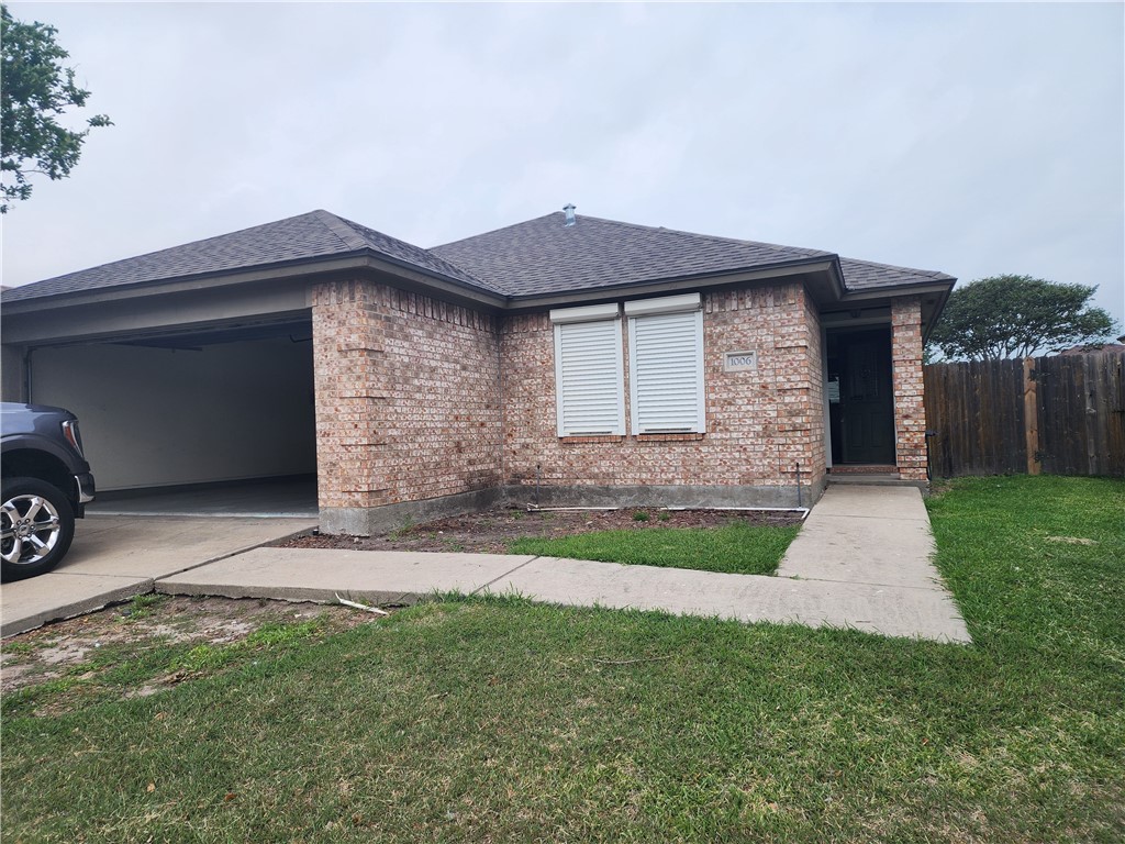 1006 Livermore Street Portland, TX 78374 - Photo 1 of 10 a front view of a house with a yard and garage