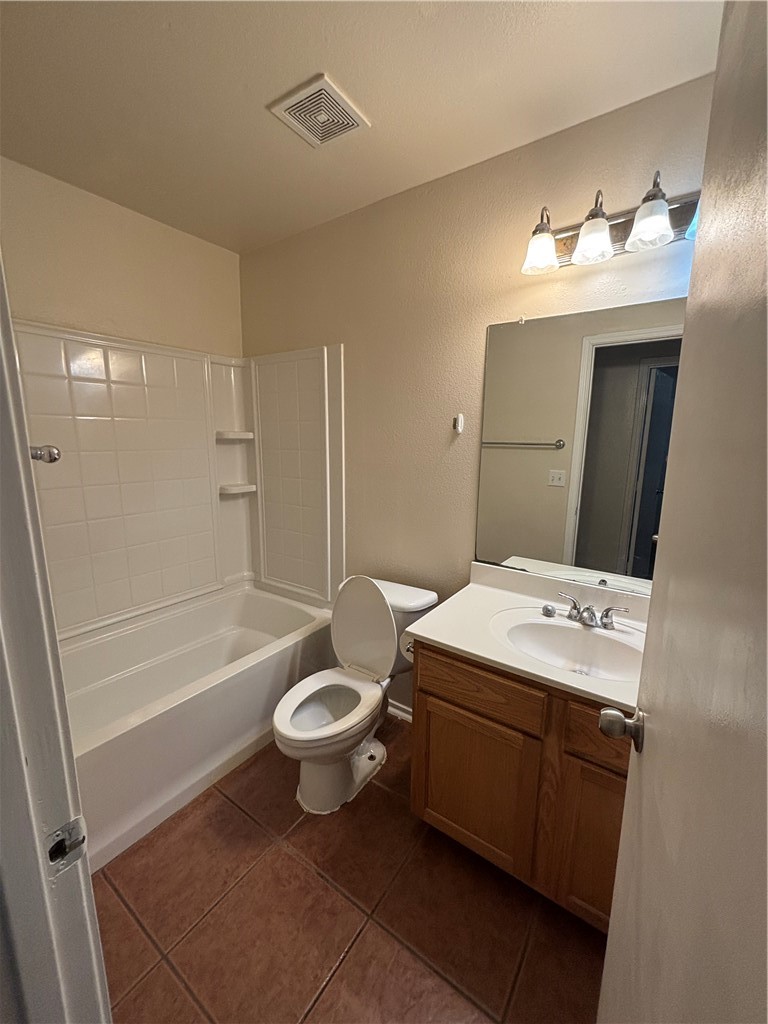 1006 Livermore Street Portland, TX 78374 - Photo 5 of 10 a bathroom with a sink toilet a mirror and bathtub