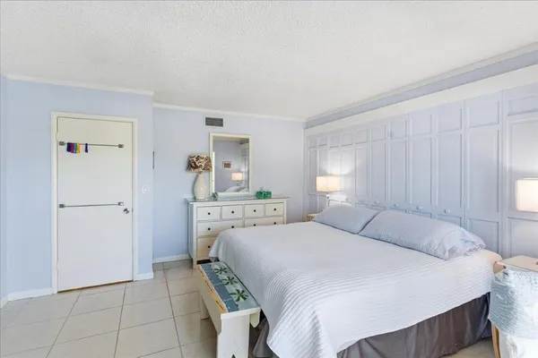 a bedroom with a large bed and a tv