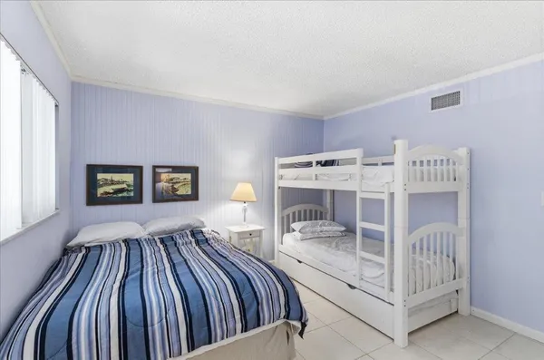 a view of a park with potted plants and a fountain
