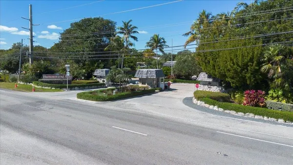 a front view of house with yard and trees around