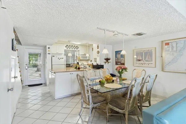a view of a dining room with furniture and a chandelier