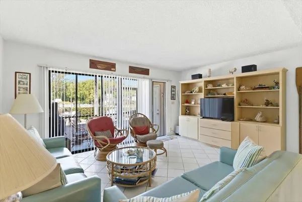 a living room with furniture and a floor to ceiling window