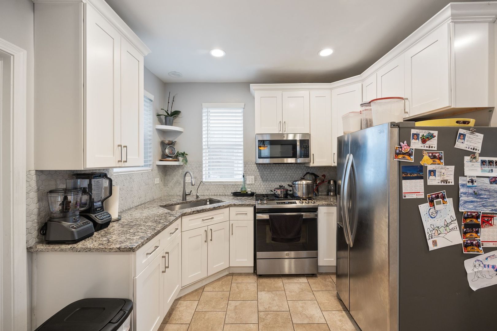439 Park Street Elgin, IL 60120 - Photo 6 of 20 a kitchen with stainless steel appliances granite countertop a refrigerator sink and stove