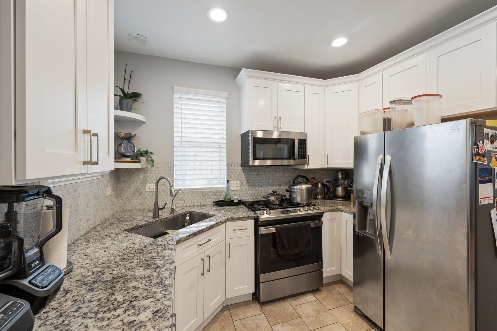 439 Park Street Elgin, IL 60120 - Photo 7 of 20 a kitchen with stainless steel appliances granite countertop a sink stove refrigerator and cabinets