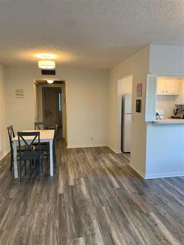 a room with wooden floor and flat screen tv