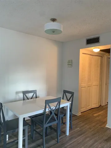 a room with a bed and a dresser