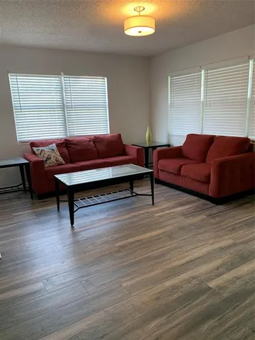 a living room with a couch and next to a window