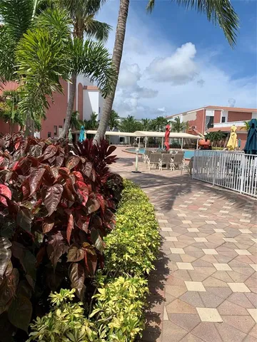 a room with furniture and view of kitchen