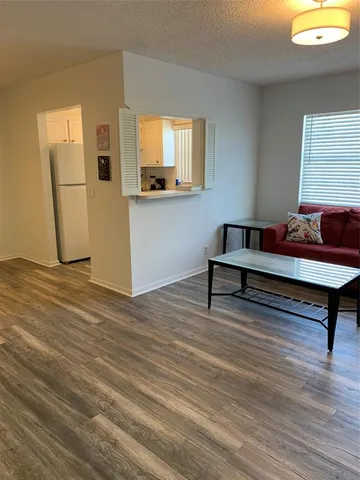 a kitchen with cabinets appliances and a window