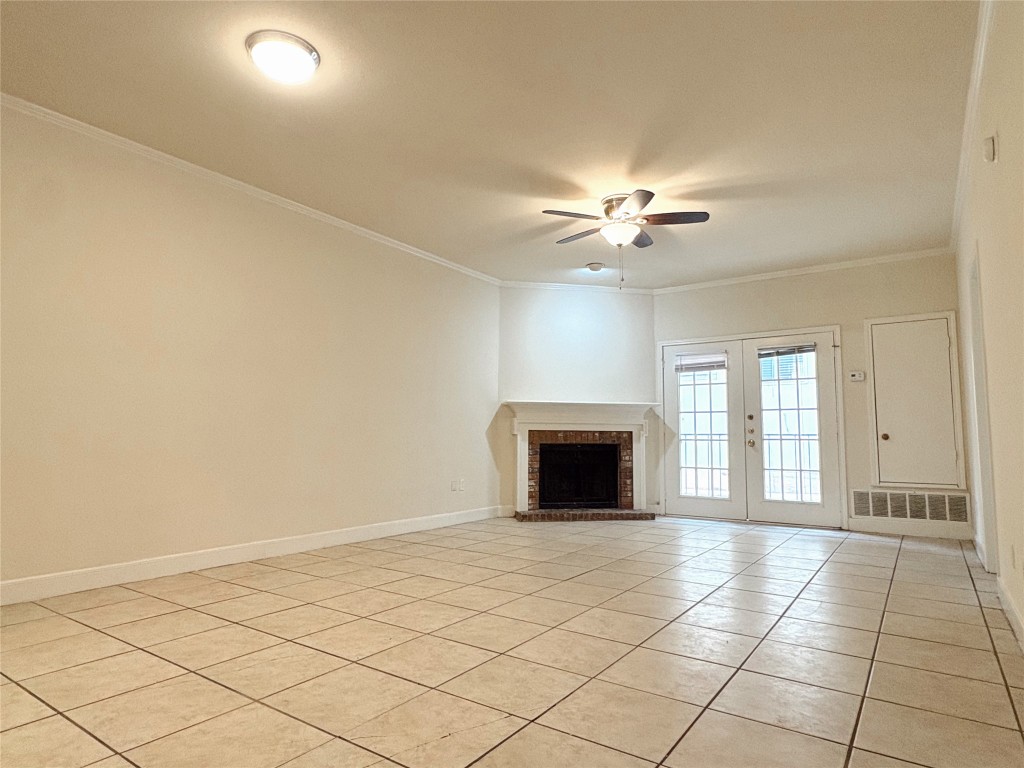2100 San Gabriel Street, Unit 104 Austin, TX 78705 - Photo 2 of 8 a view of an empty room with a fireplace and a chandelier fan