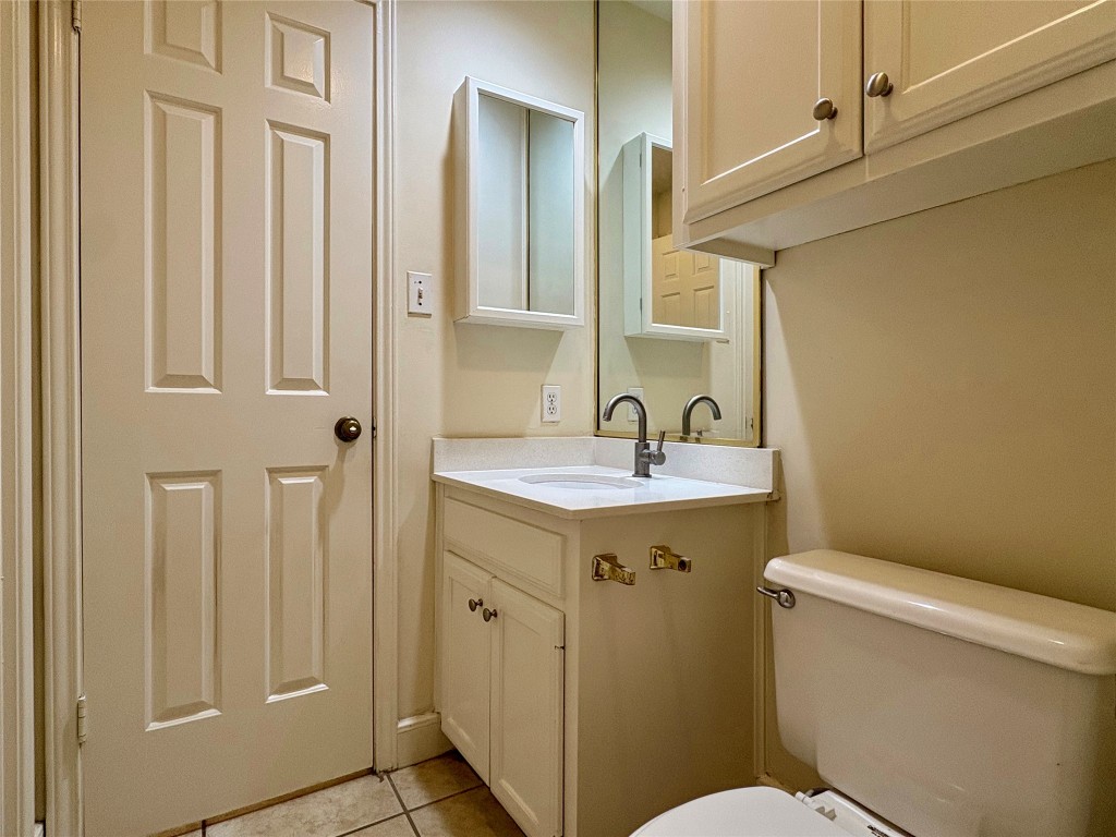 2100 San Gabriel Street, Unit 104 Austin, TX 78705 - Photo 8 of 8 a bathroom with a sink a toilet a mirror and shower