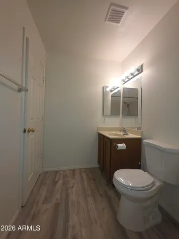 a bathroom with a toilet a sink and mirror