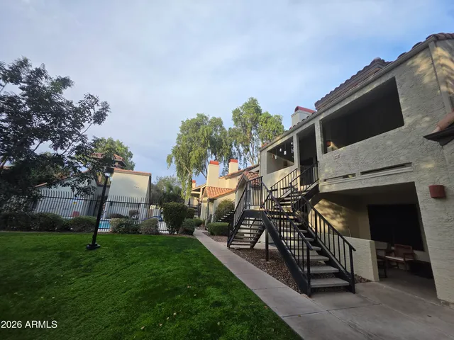 a view of a small house with a yard