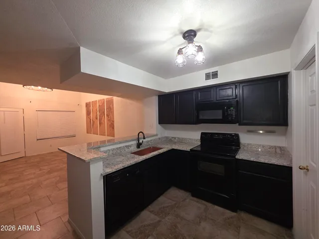 a kitchen with a sink and chandelier