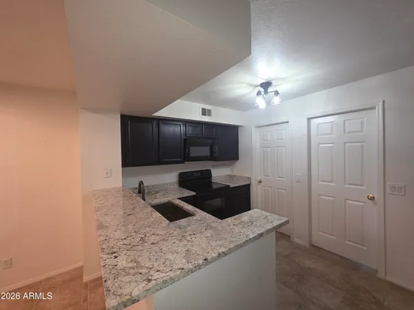 a kitchen with a sink a counter top space and cabinets