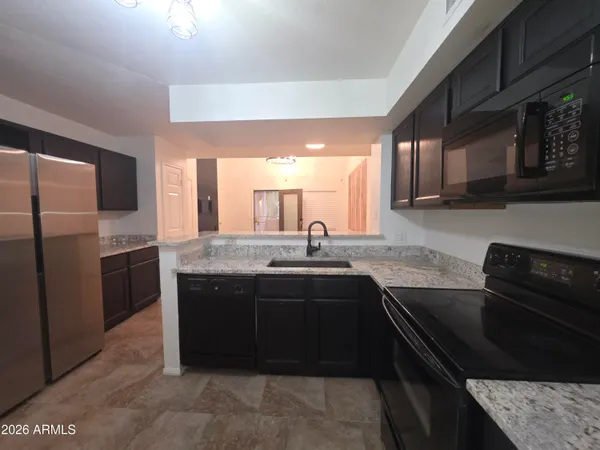 a kitchen with a sink and stainless steel appliances