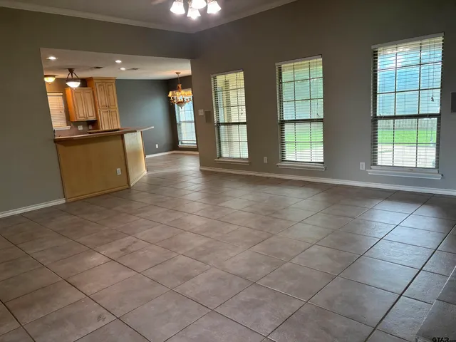 an empty room with a fireplace and windows