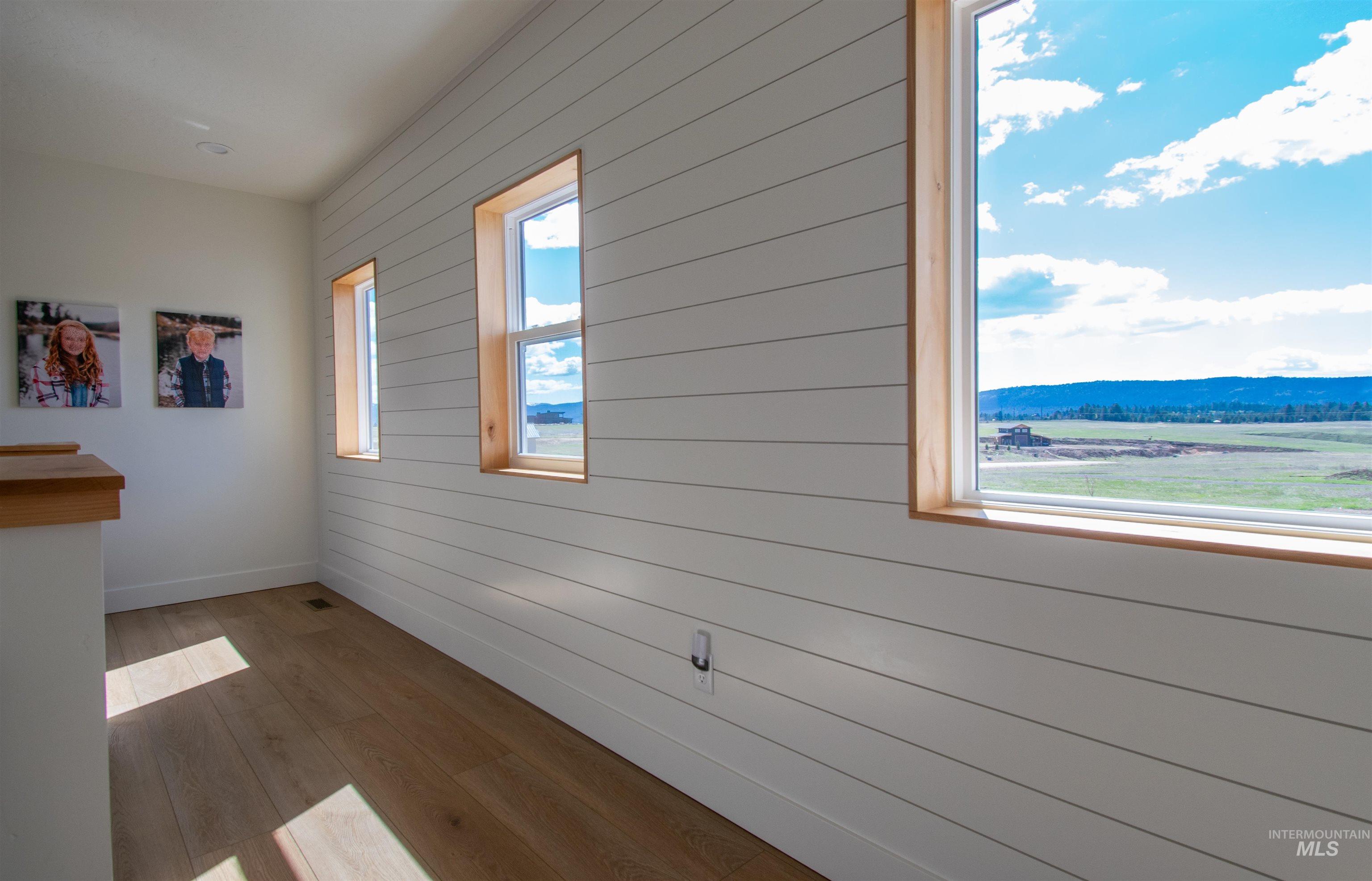 44 Big Moose Road McCall, ID 83638 - Photo 22 of 50 Interior space featuring white shiplap wall paneling and warm wood-finish flooring