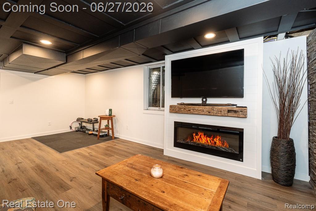 1222 Kings Cove Court, Unit 244 Rochester, MI 48306 - Photo 27 of 44 Additional 240 sq ft with built-in electric fireplace with vintage1800's hand hewn barn bean mantle