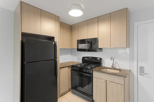 a kitchen with a refrigerator stove and microwave
