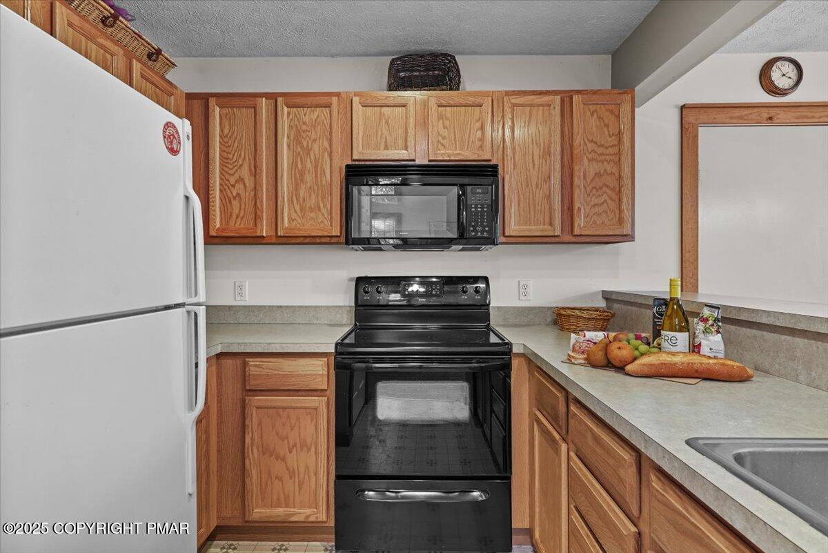 182 Upper Deer Valley Road Tannersville, PA 18372 - Photo 13 of 40 a kitchen with a stove top oven and cabinets