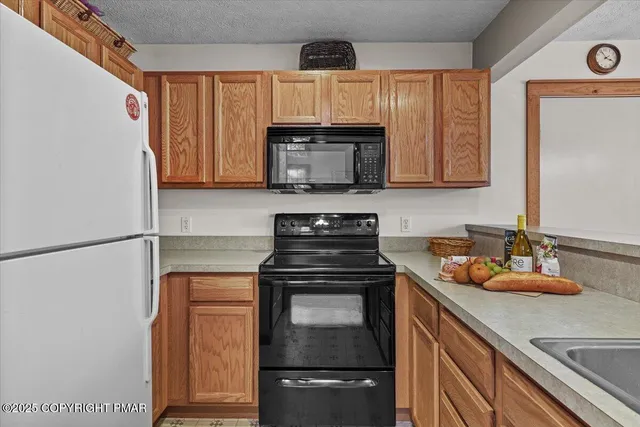 a bathroom with a granite countertop toilet sink and mirror