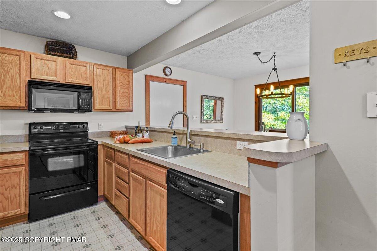 182 Upper Deer Valley Road Tannersville, PA 18372 - Photo 16 of 41 a kitchen with a sink stove and microwave