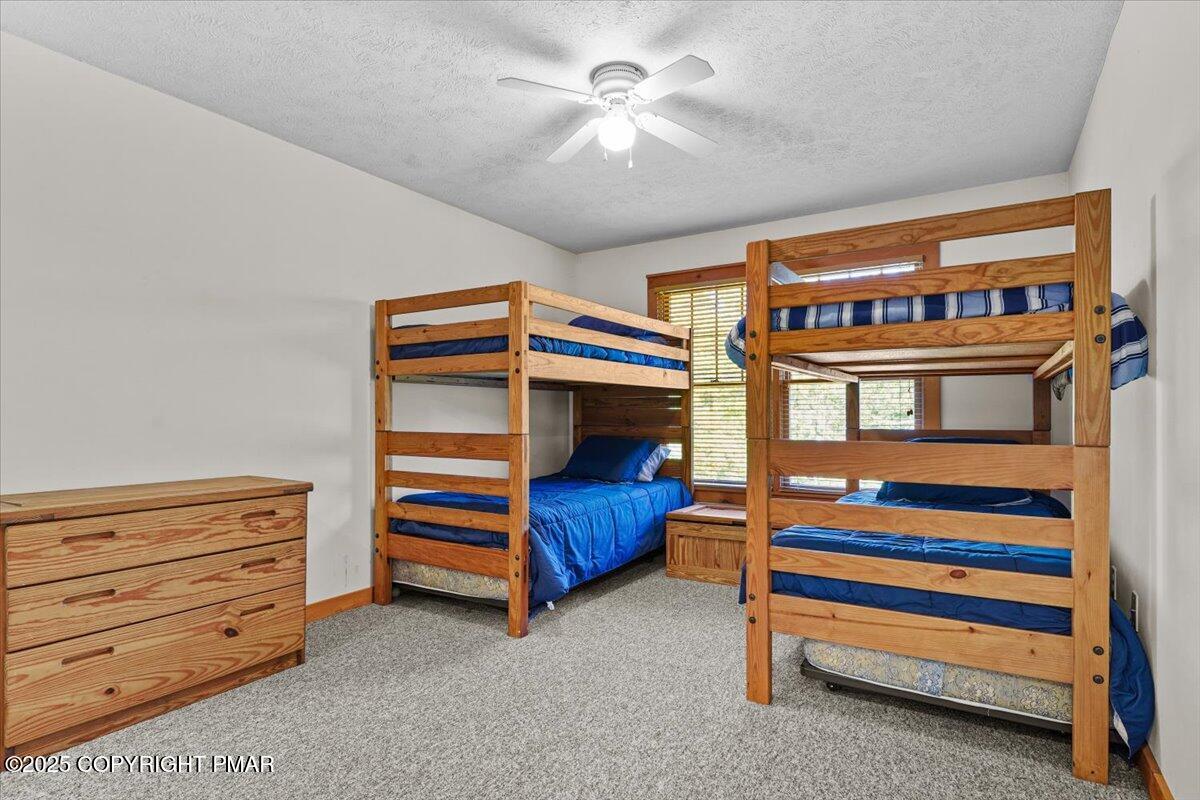 182 Upper Deer Valley Road Tannersville, PA 18372 - Photo 21 of 40 a bedroom with a bunk bed and a dresser