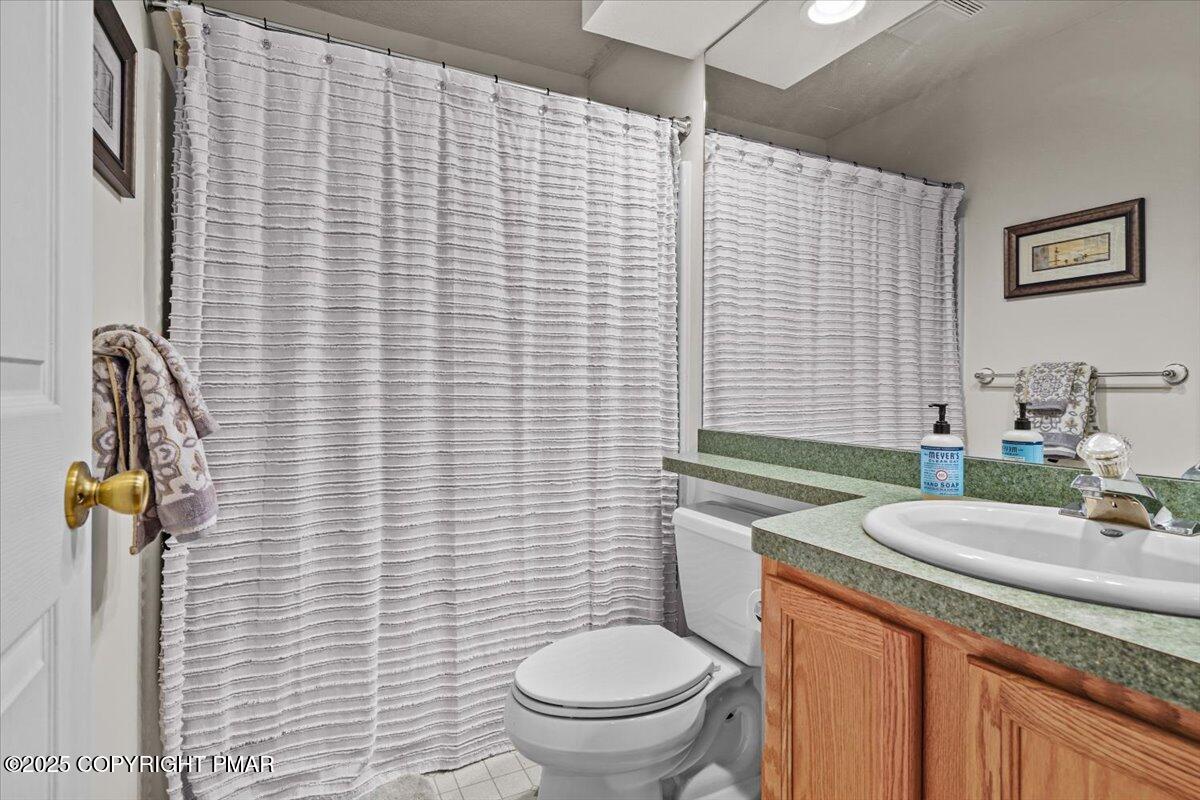 182 Upper Deer Valley Road Tannersville, PA 18372 - Photo 25 of 40 a bathroom with a granite countertop toilet a sink and mirror