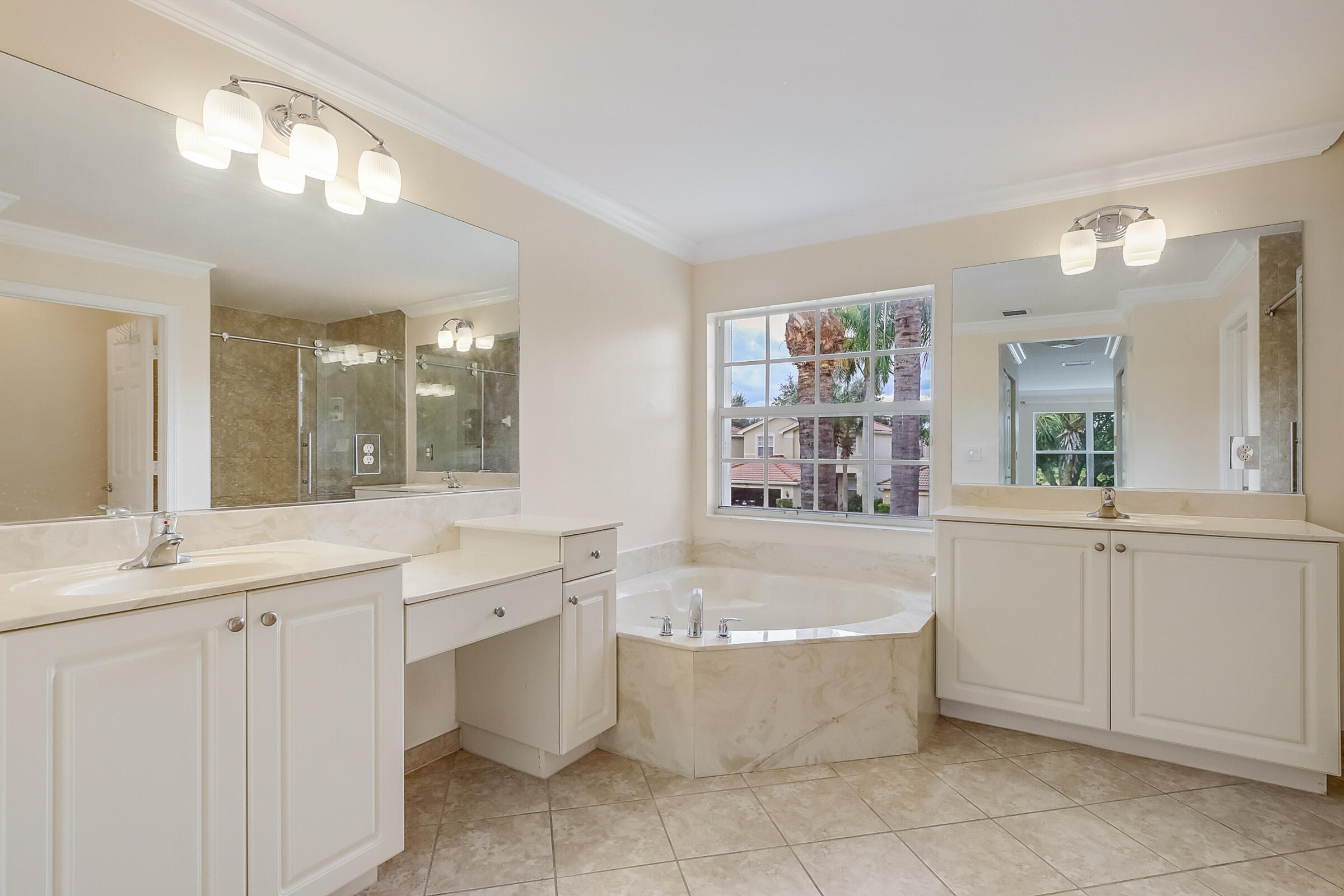 10208 White Water Lily Way Boynton Beach, FL 33437 - Photo 14 of 38 a large bathroom with a tub a sink shower and mirror