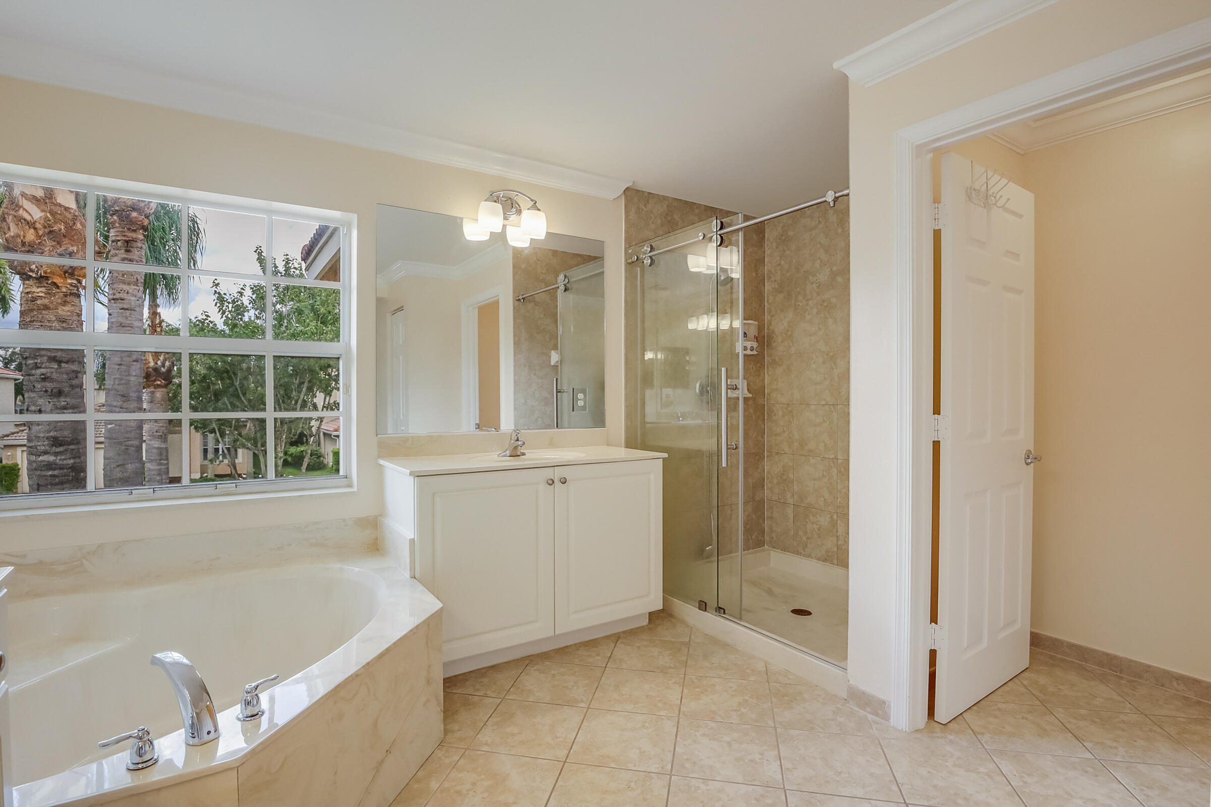 10208 White Water Lily Way Boynton Beach, FL 33437 - Photo 15 of 38 a bathroom with a tub shower and sink