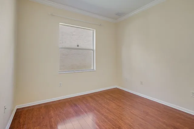 a view of a room with wooden floor
