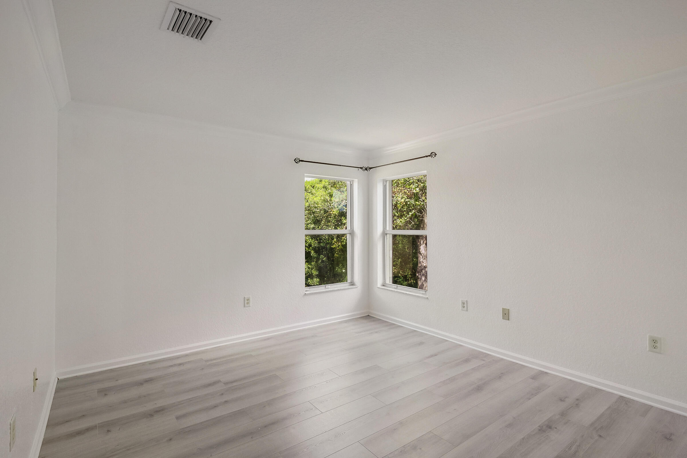 10208 White Water Lily Way Boynton Beach, FL 33437 - Photo 19 of 38 an empty room with wooden floor and windows