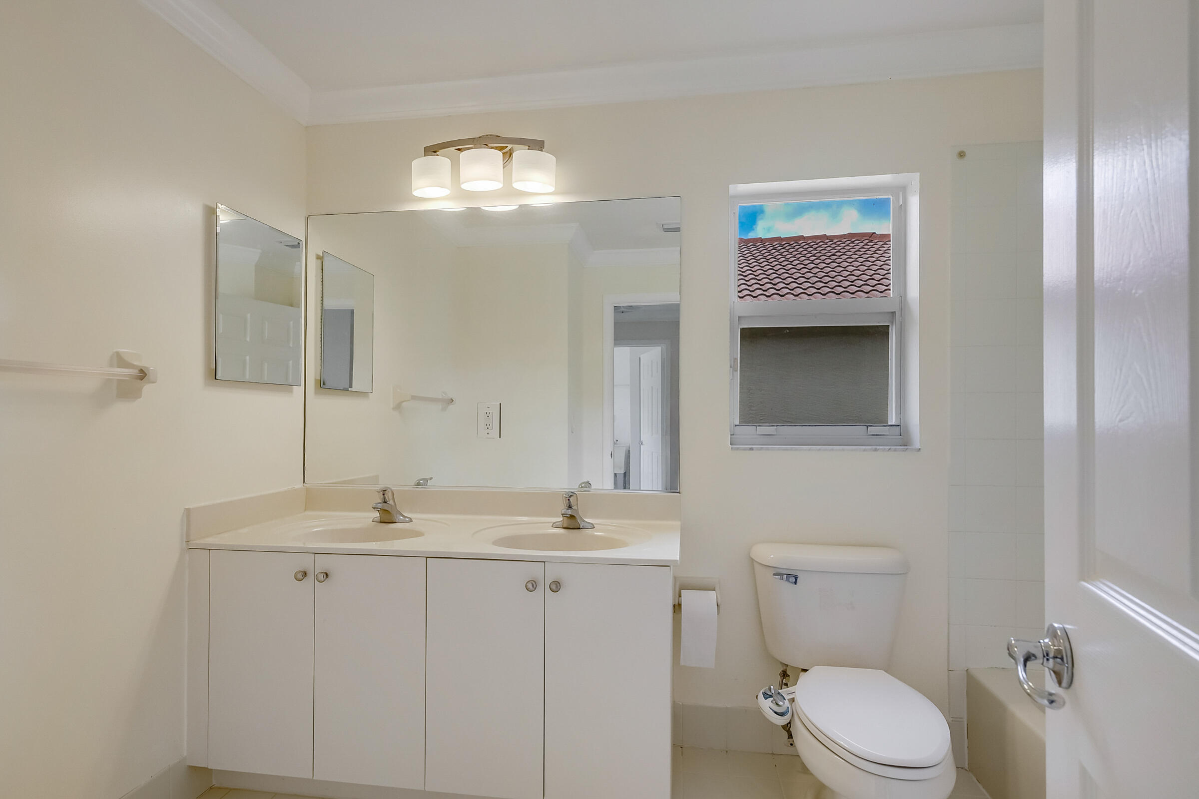 10208 White Water Lily Way Boynton Beach, FL 33437 - Photo 27 of 38 a bathroom with a toilet sink and mirror