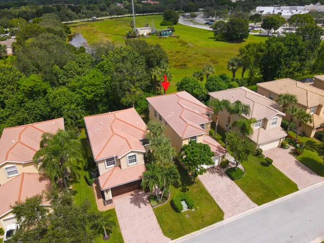 a aerial view of a house with a yard and outdoor seating