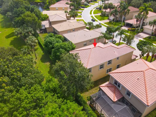 an aerial view of a house with a garden and lake view