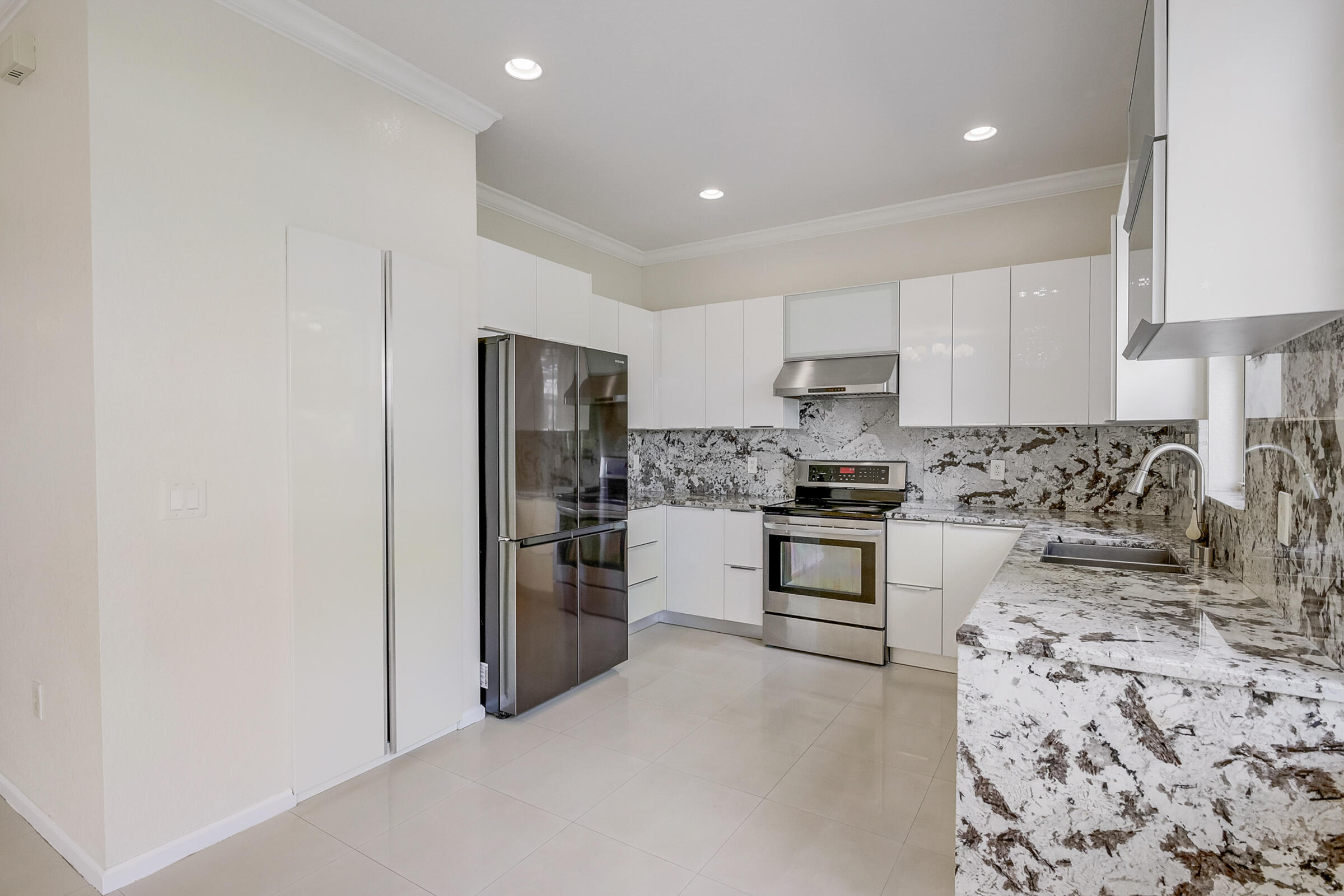 10208 White Water Lily Way Boynton Beach, FL 33437 - Photo 8 of 38 a kitchen with stainless steel appliances granite countertop a refrigerator stove oven and sink