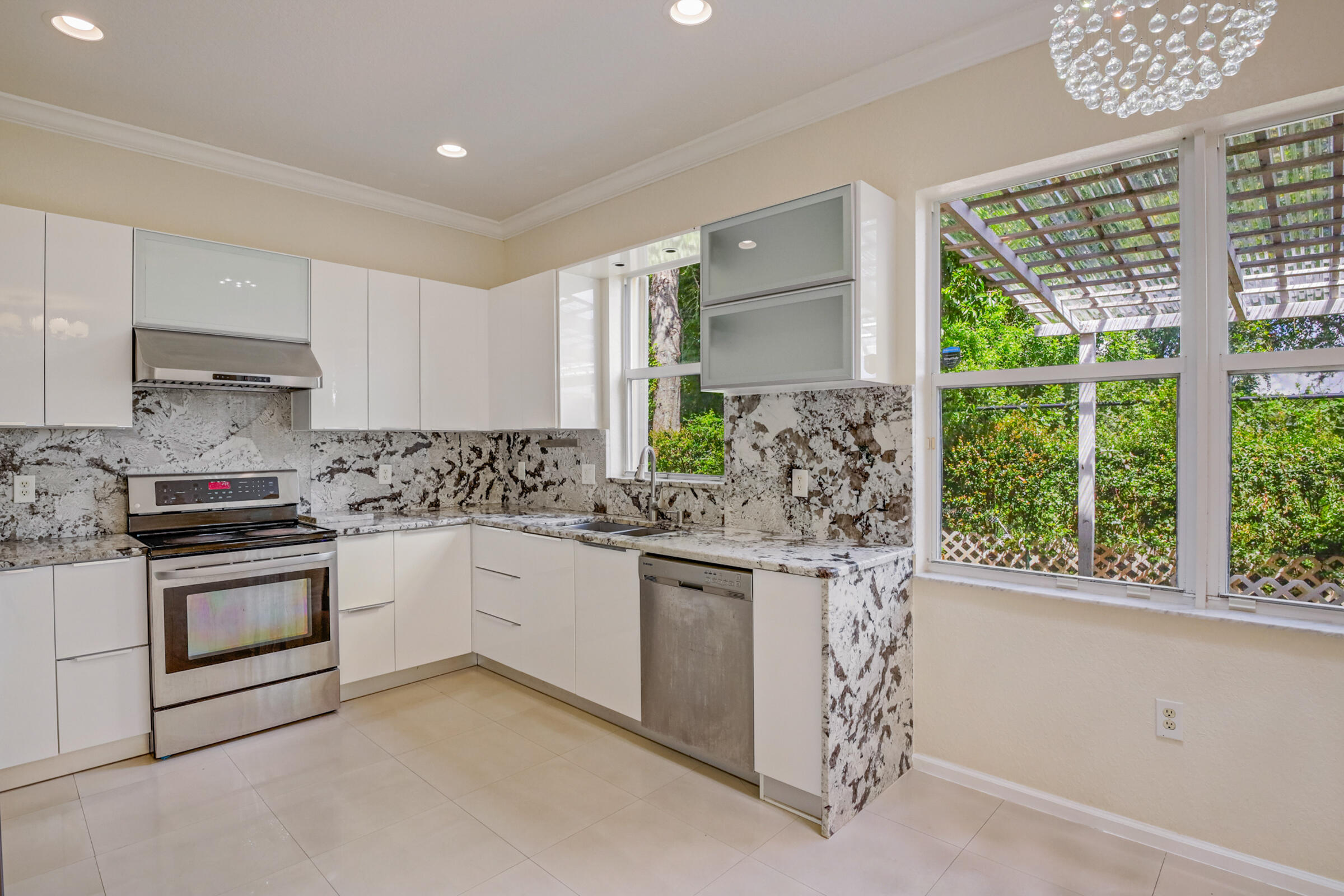 10208 White Water Lily Way Boynton Beach, FL 33437 - Photo 10 of 38 a kitchen with stainless steel appliances granite countertop a stove a sink and a microwave