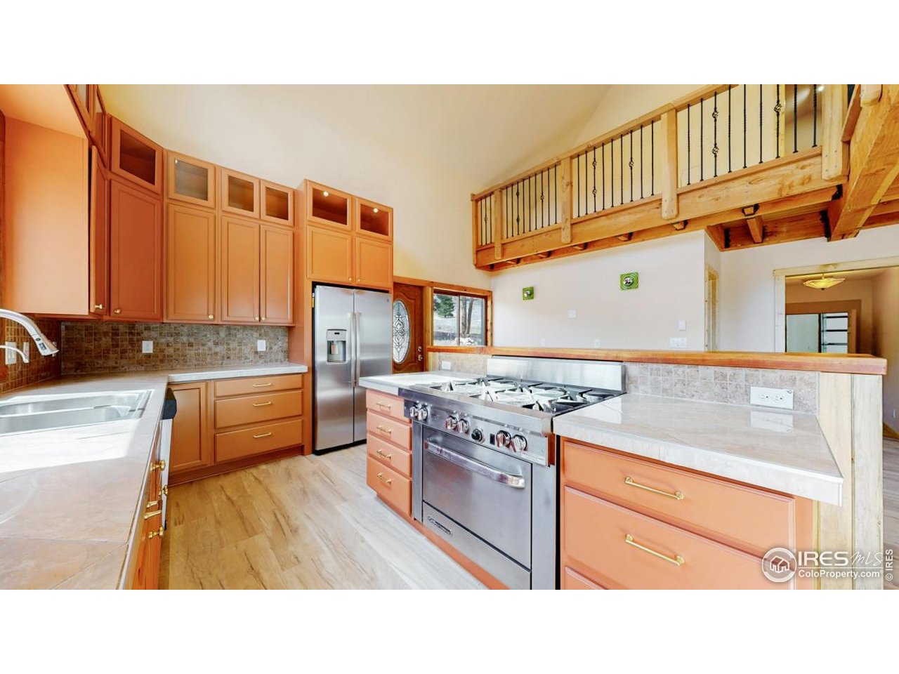598 Taylor Road Lyons, CO 80540 - Photo 6 of 32 a kitchen with stainless steel appliances granite countertop a stove a sink and a refrigerator