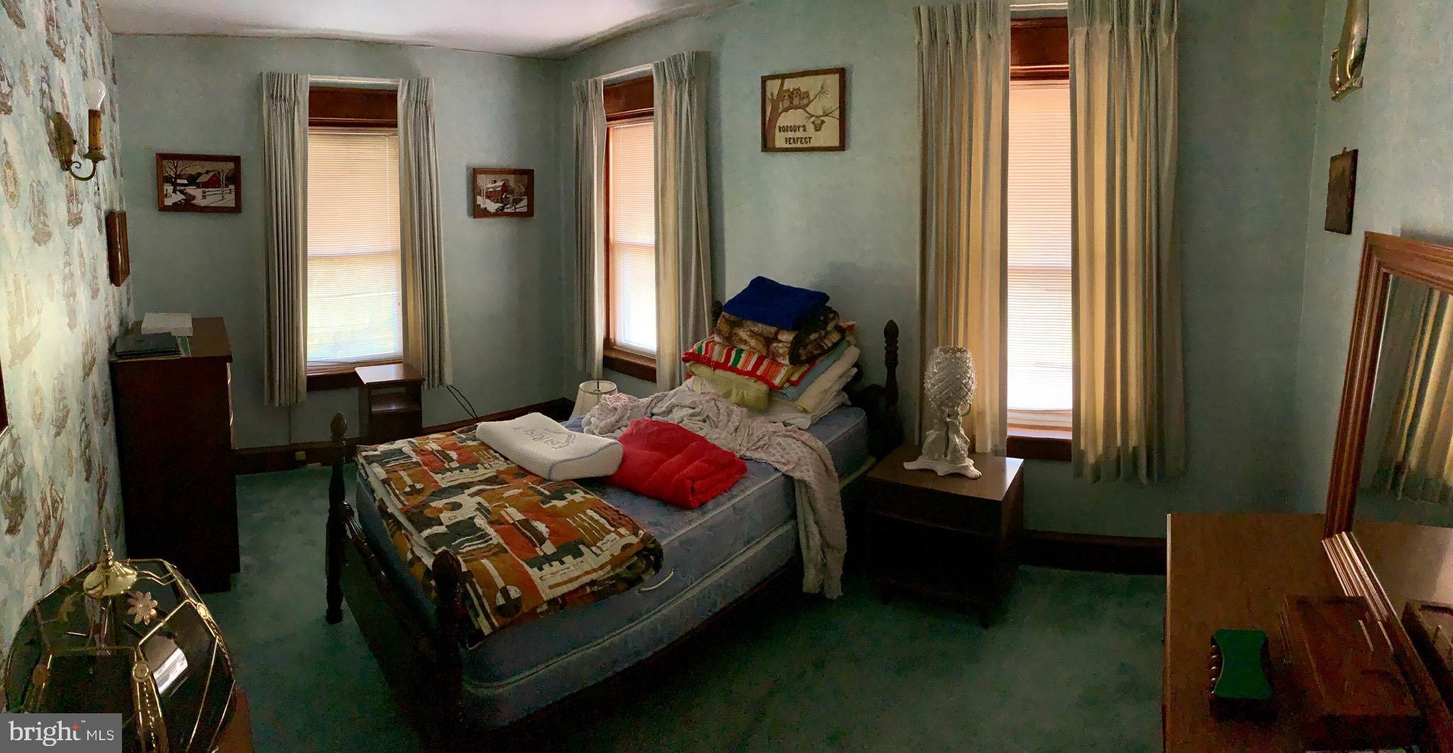 931 Fritztown Road Reading, PA 19608 - Photo 11 of 12 a bedroom with a bed next to a window
