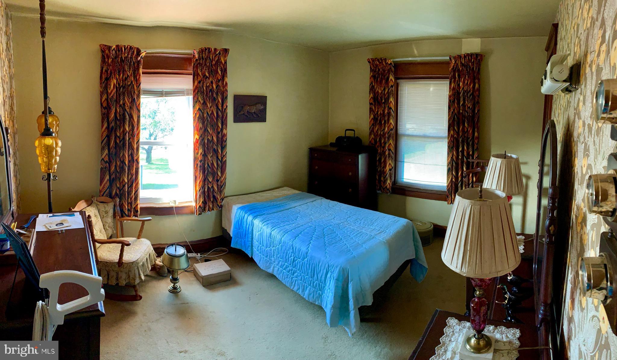 931 Fritztown Road Reading, PA 19608 - Photo 8 of 12 a bedroom with bed and next to a window