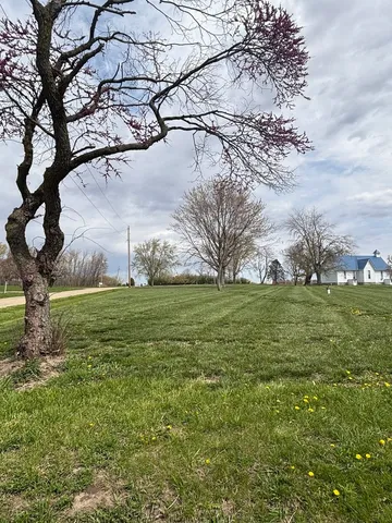 a backyard of a house with lots of green space