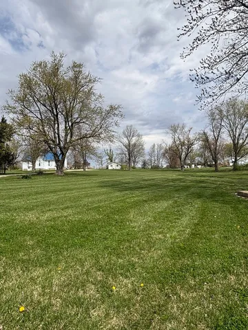a view of a field with trees