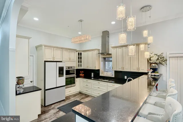 a kitchen with granite countertop a sink a counter top space appliances and cabinets
