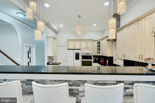 a kitchen with granite countertop a sink stainless steel appliances and cabinets