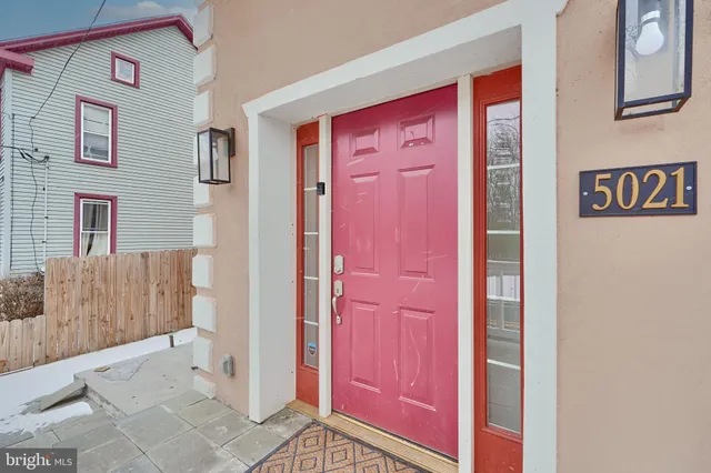 a large white kitchen with wooden floor and a counter top space