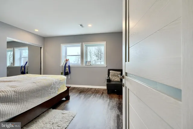 a bedroom with a bed and a dresser in it